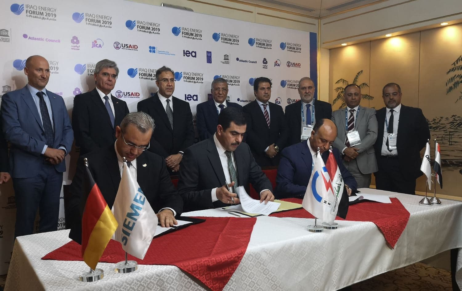 From (L to R) Karim Amin, CEO of Siemens Power Generation, Waleed Khaled Hassan, director general, general state company for electricity production north region and Orascom CEO Osama Bishai, sign a contract in the Iraqi capital Baghdad, September 14, 2019. Photo: Maya Gebeily / AFP