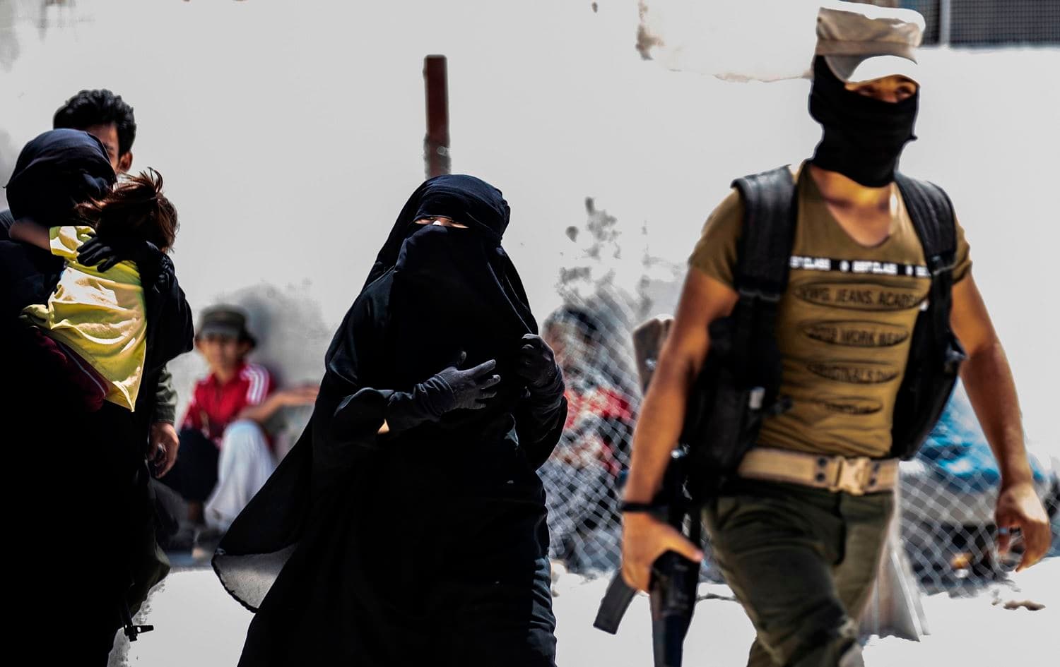 A woman moves through al-Hol camp in July 2019. Photo: AFP