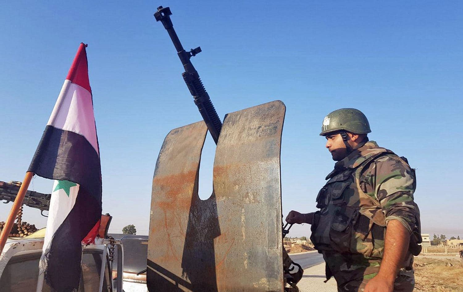 A Syrian regime soldier is posted at the western entrance of the town of Tal Tamr in the countryside of Syria's northeastern Hasaka province, October 14, 2019. Photo: SANA / HO / AFP
