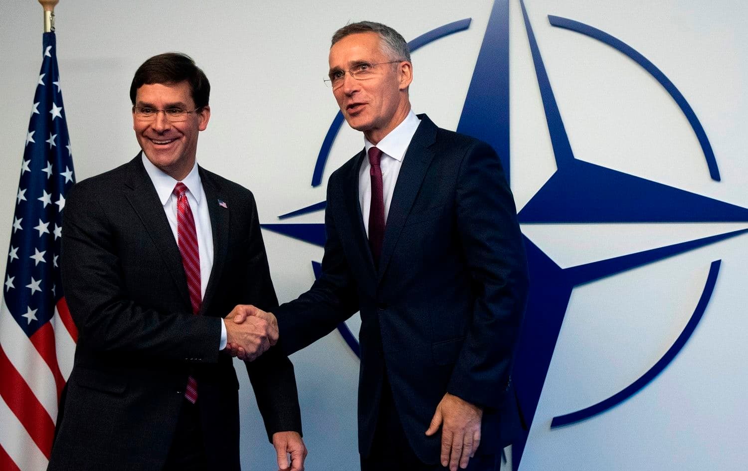 US Defence Secretary Mark Esper (L) shakes hand with NATO Secretary General Jens Stoltenberg at the NATO headquarters in Brussels, October 24, 2019. Photo: Virginia Mayo / pool / AFP
