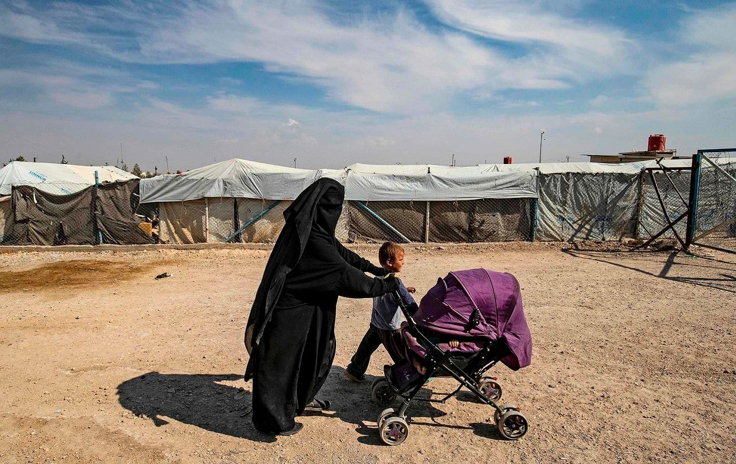 A woman accompanies children at the Kurdish-run al-Hol camp for the displaced where families of Islamic State (ISIS) foreign fighters are held, in the Hasaka governorate of northeast Syria, October 17, 2019. Photo: Delil Souleiman / AFP