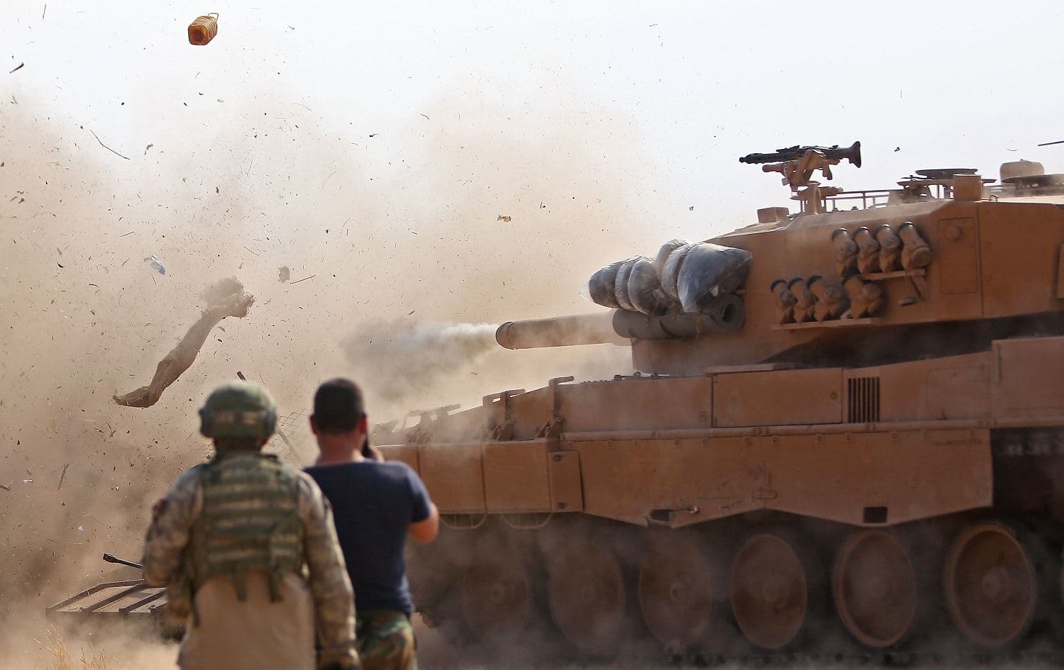 Turkish soldiers east of Ras al-AIn, northern Syria, watch as a tank fires on positions held by the Syrian Democratic Forces (SDF), October 28, 2019. Photo: Nazeer al-Khatib / AFP