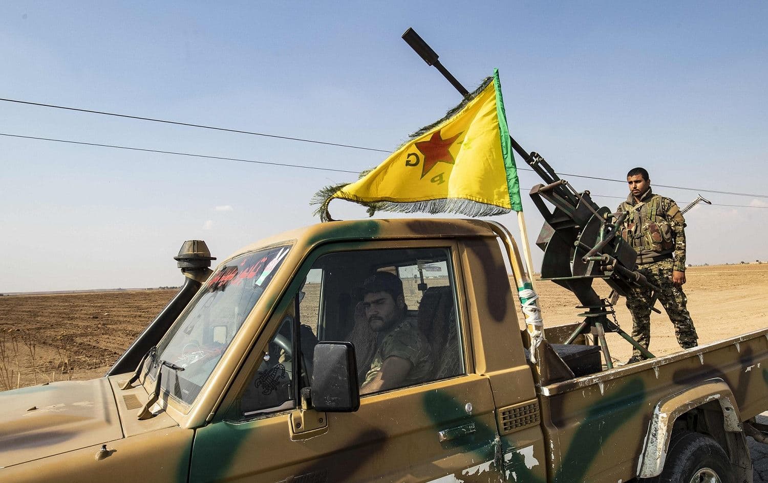 Fighters of the Syrian Democratic Forces (SDF) prepare to withdraw from the Sanjak Saadoun border area near the northern Syrian town of Amuda, October 27, 2019. Photo: Delil Souleiman / AFP