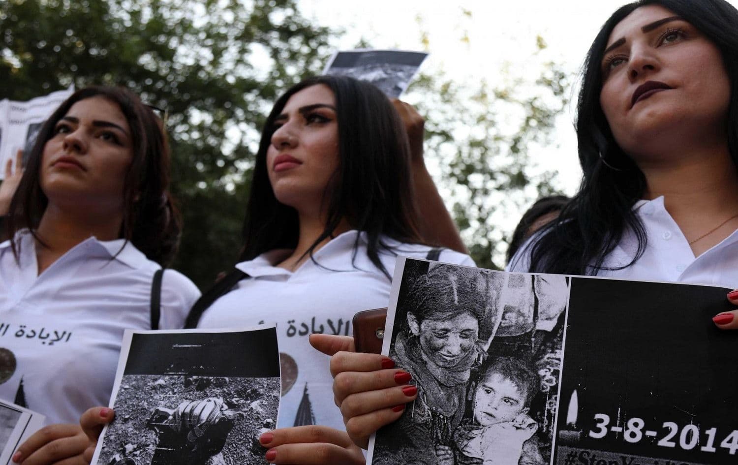 Yezidi women commemorate the ISIS attack on their community which left thousands missing. Photo: AFP