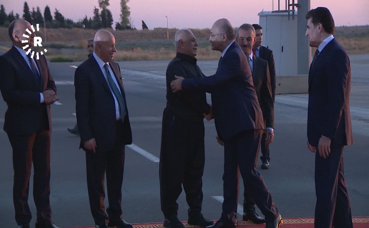 President of Iraq Barham Salih greets Kurdish party leaders upon landing at Erbil International Airport on November 4, 2019, alongside President of the Kurdistan Region Nechirvan Barzani (right)