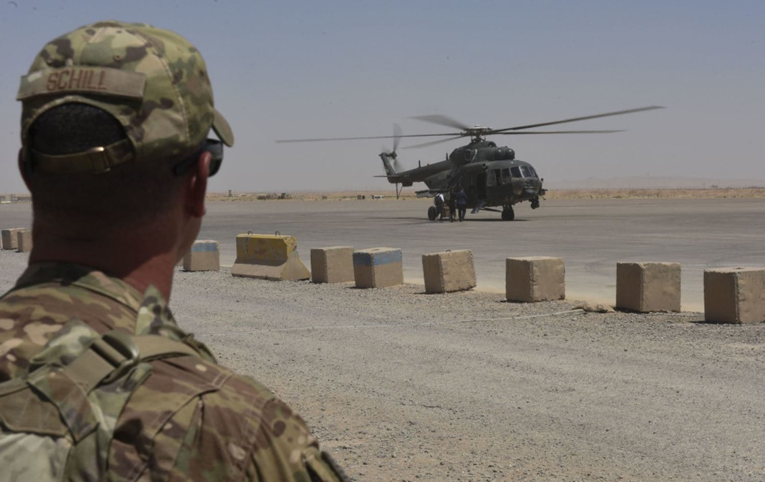 A US soldier watches people board an Iraqi Air Force helicopter at Qayyarah Airfield West on July 19, 2018. Photo: Tech. Sgt. Caleb Pierce/US Air Force