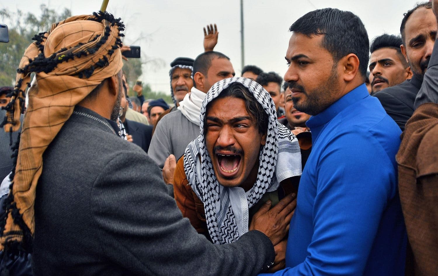 An Iraqi mourner reacts during a funeral procession for anti-government demonstrators killed during protests a day earlier, in the central holy shrine city of Najaf, November 29, 2019. Photo: Haidar Hamdani / AFP