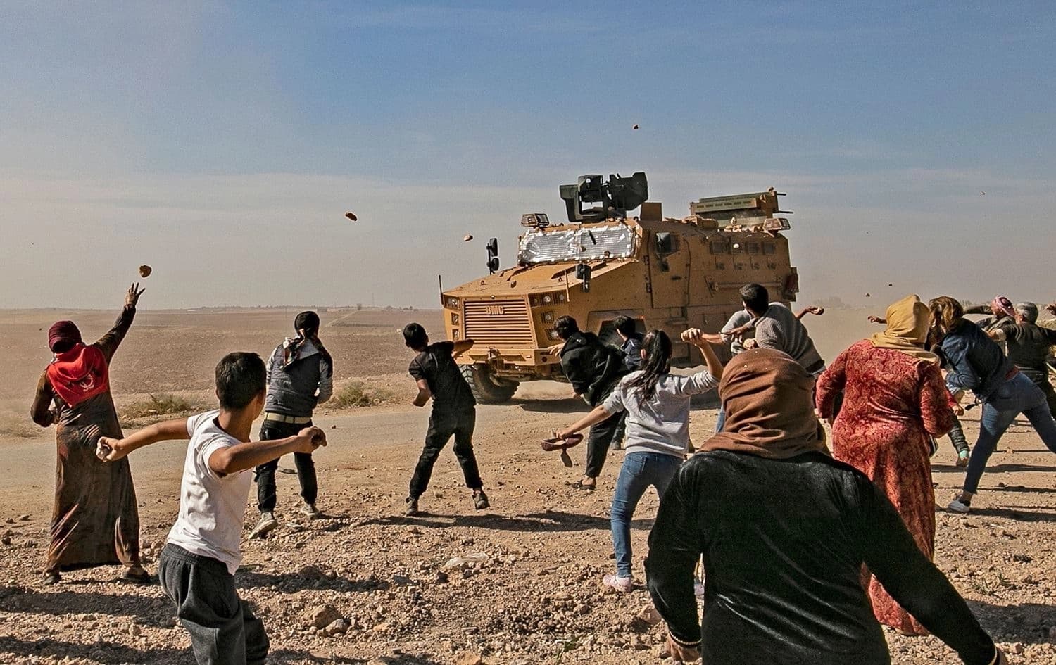 Syrians throw stones at Turkish military vehicles during a Turkish-Russian army patrol near the town of Darbasiyah, November 11, 2019. File photo: Delil Souleiman / AFP