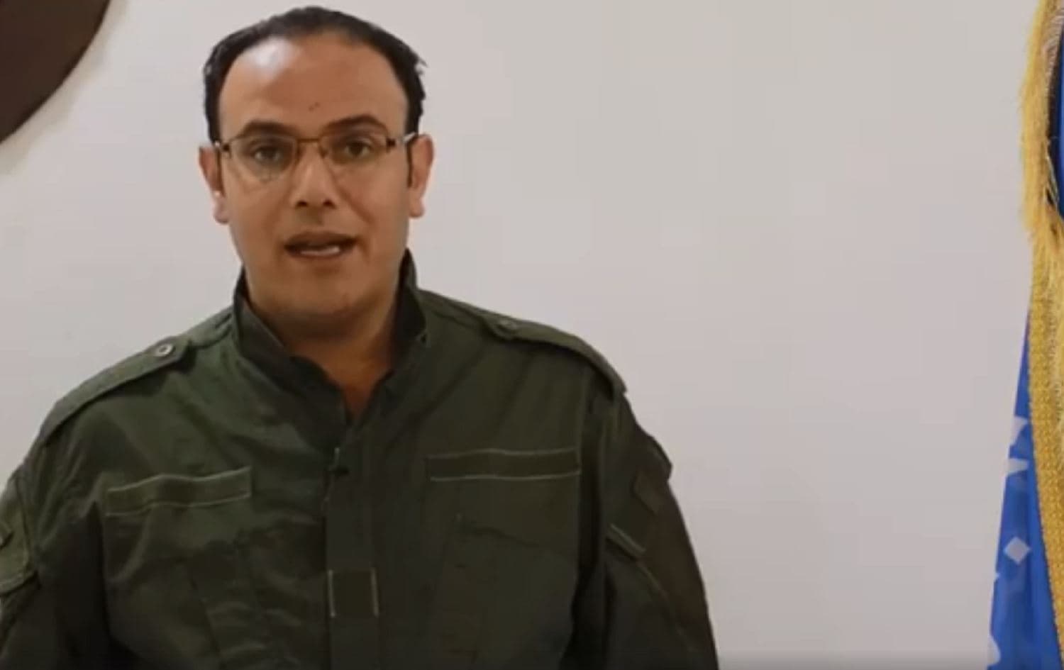 Screenshot of Rojava Asayesh spokesperson Ali Hassan announcing the release of an ENKS member via televised statement on Friday. Photo/video: social media