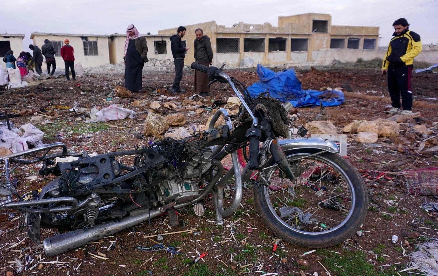 Syrians gather at the site of a Russian air strike in the village of Jubass on the outskirts of Saraqeb in Idlib on December 24, 2019. Photo: Muhammad Haj Kadour/AFP
