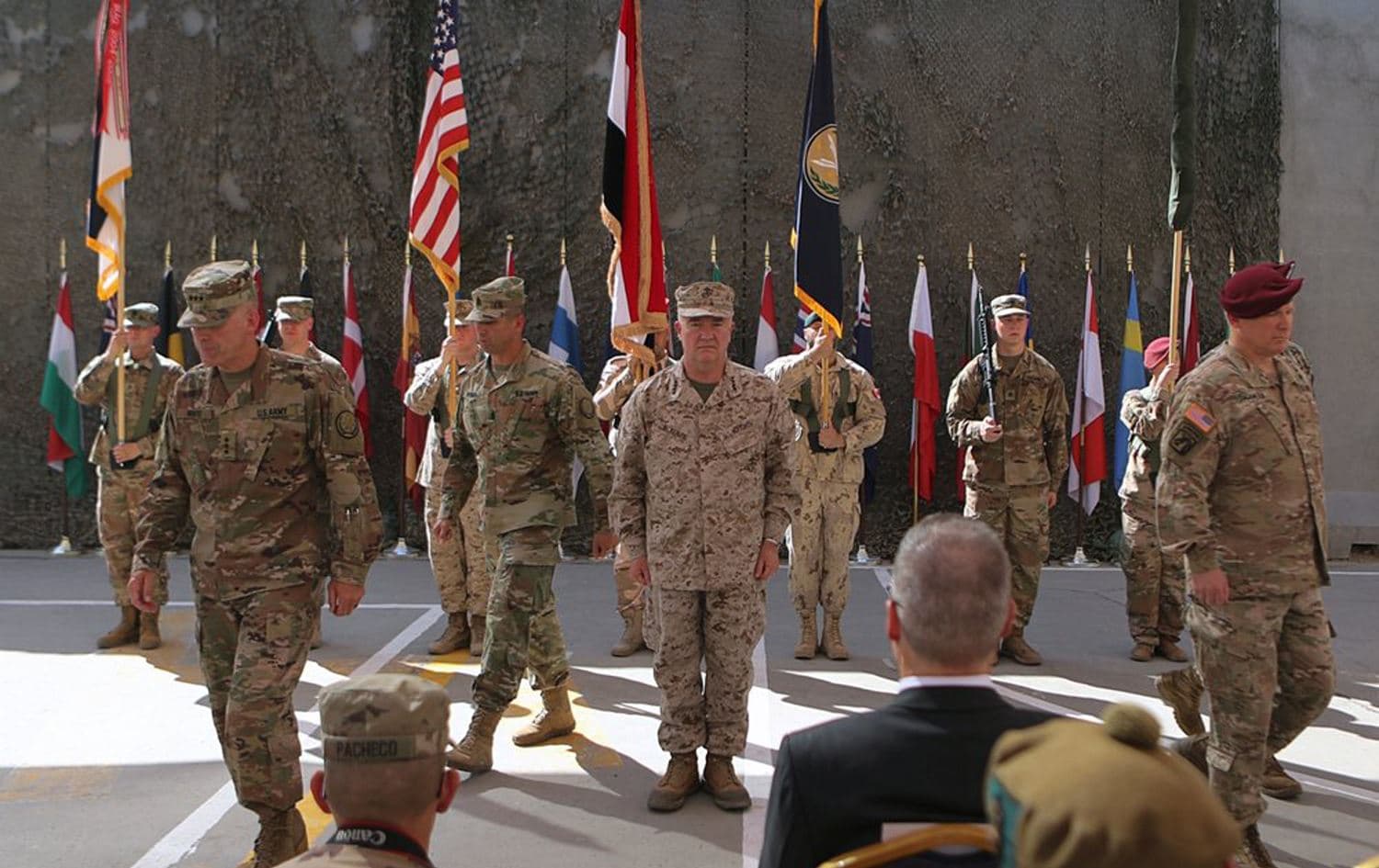 U.S. Army Lt. Gen. Pat White, III Armored Corps Commanding General, second left, and Commanding General for U.S. Central Command Gen. Kenneth F. McKenzie Jr. center, take part in a transfer of authority ceremony at Union III base in Baghdad September 4, 2019. Photo: AP / Khalid Mohammed, File