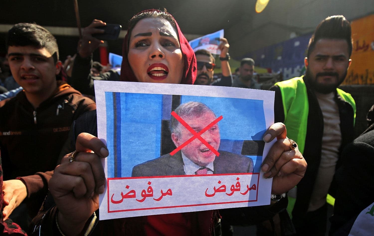 An Iraqi protester holds a picture of Prime Minister-designate Mohammad Tofiq Allawi with the inscription “rejected” during an anti-government demonstration in Baghdad, February 4, 2020. Photo: Ahmad al-Rubaye / AFP