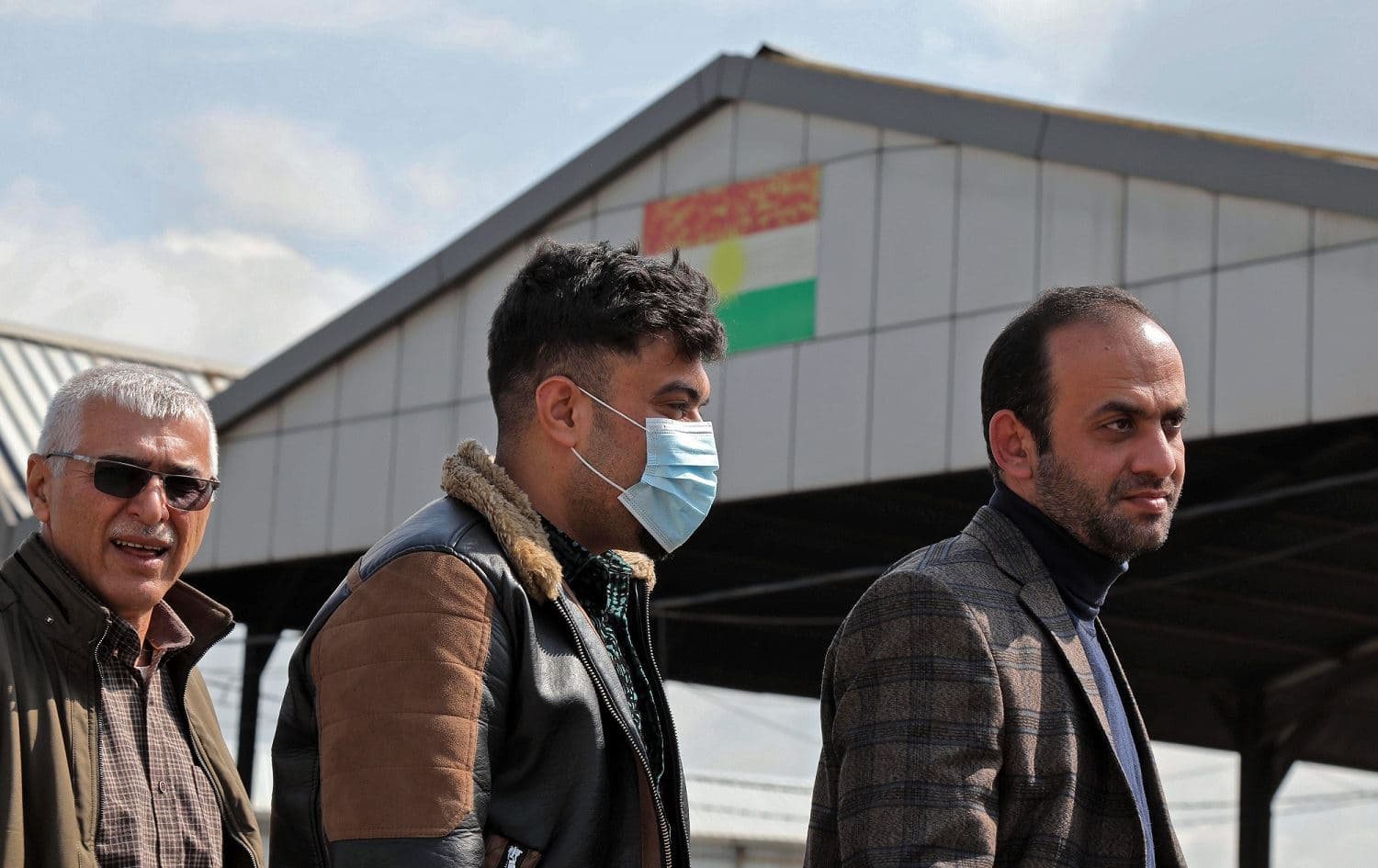 Travelers wait to have their temperature checked at an Erbil checkpoint, March 2, 2020. Photo: Safin Hamed / AFP