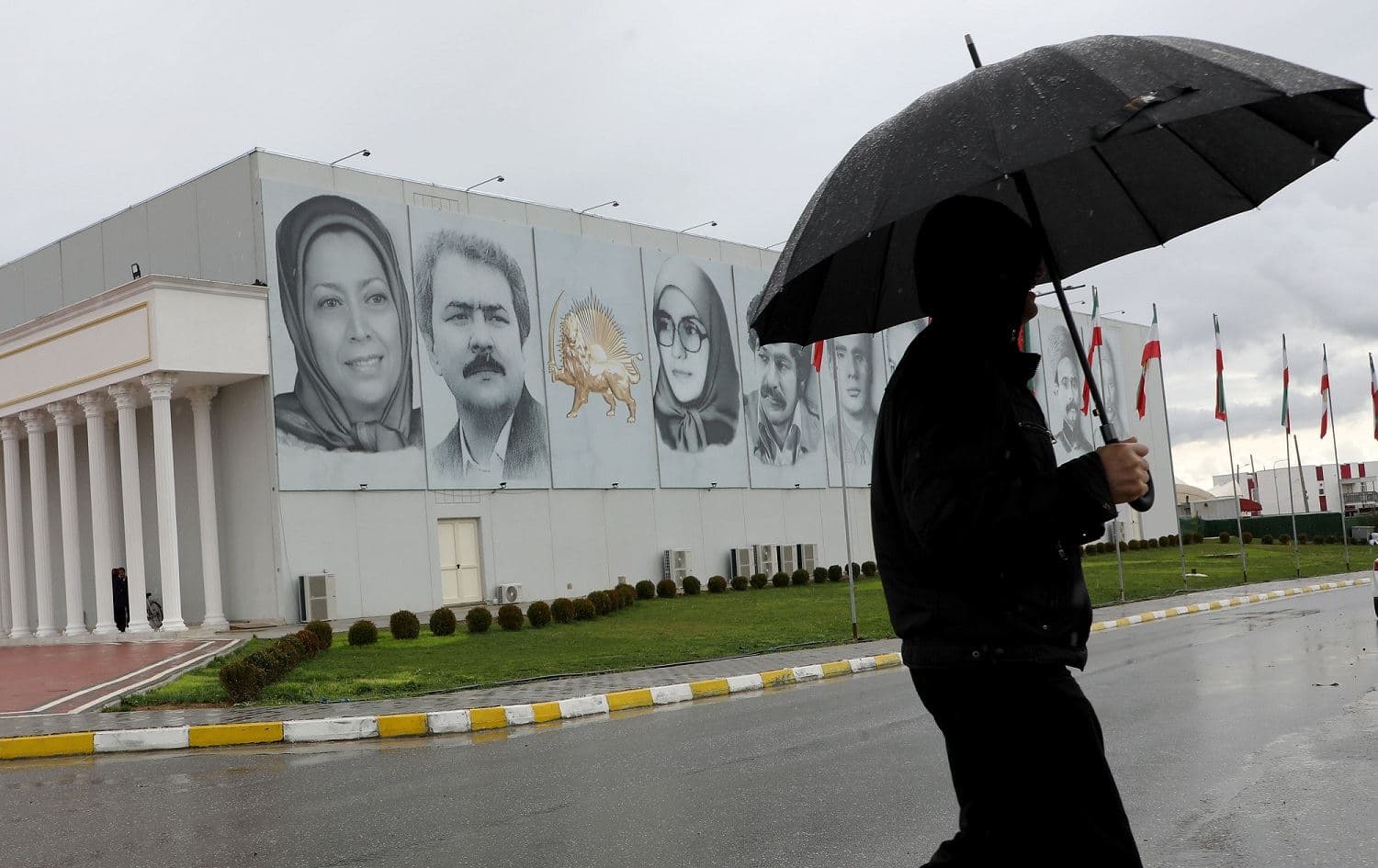 A member of Mujahedin-e Khalq walks in a street at the Ashraf-3 camp, which is a base for the People's Mojahedin Organization of Iran (MEK) in Manza, March 4, 2020. Photo: Gent Shkullaku / AFP
