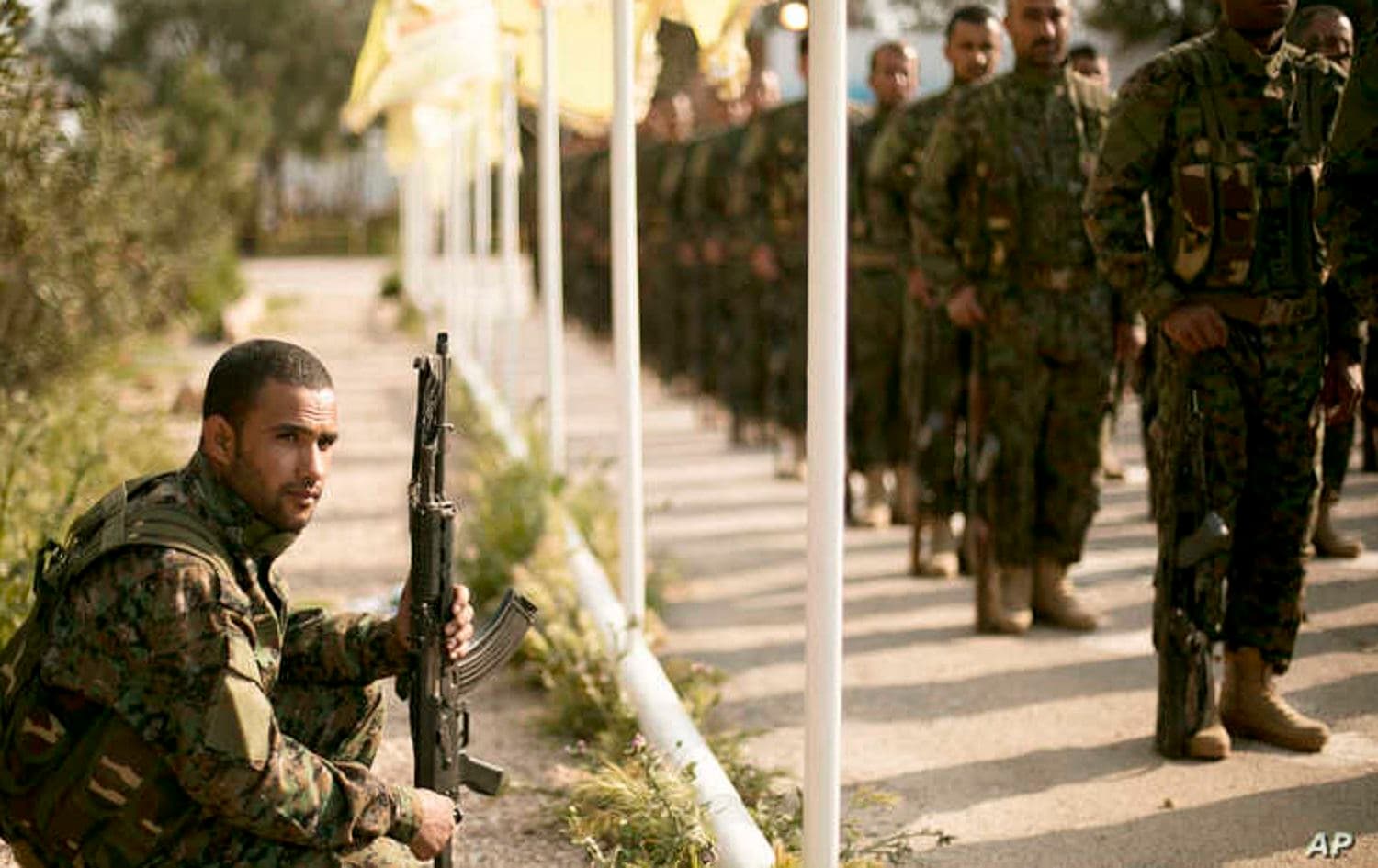 Members of the Syrian Democratic Forces (SDF) stand in formation at a ceremony to mark their defeat of Islamic State militants in Baghouz, Syria on March 23, 2019. File photo: AP