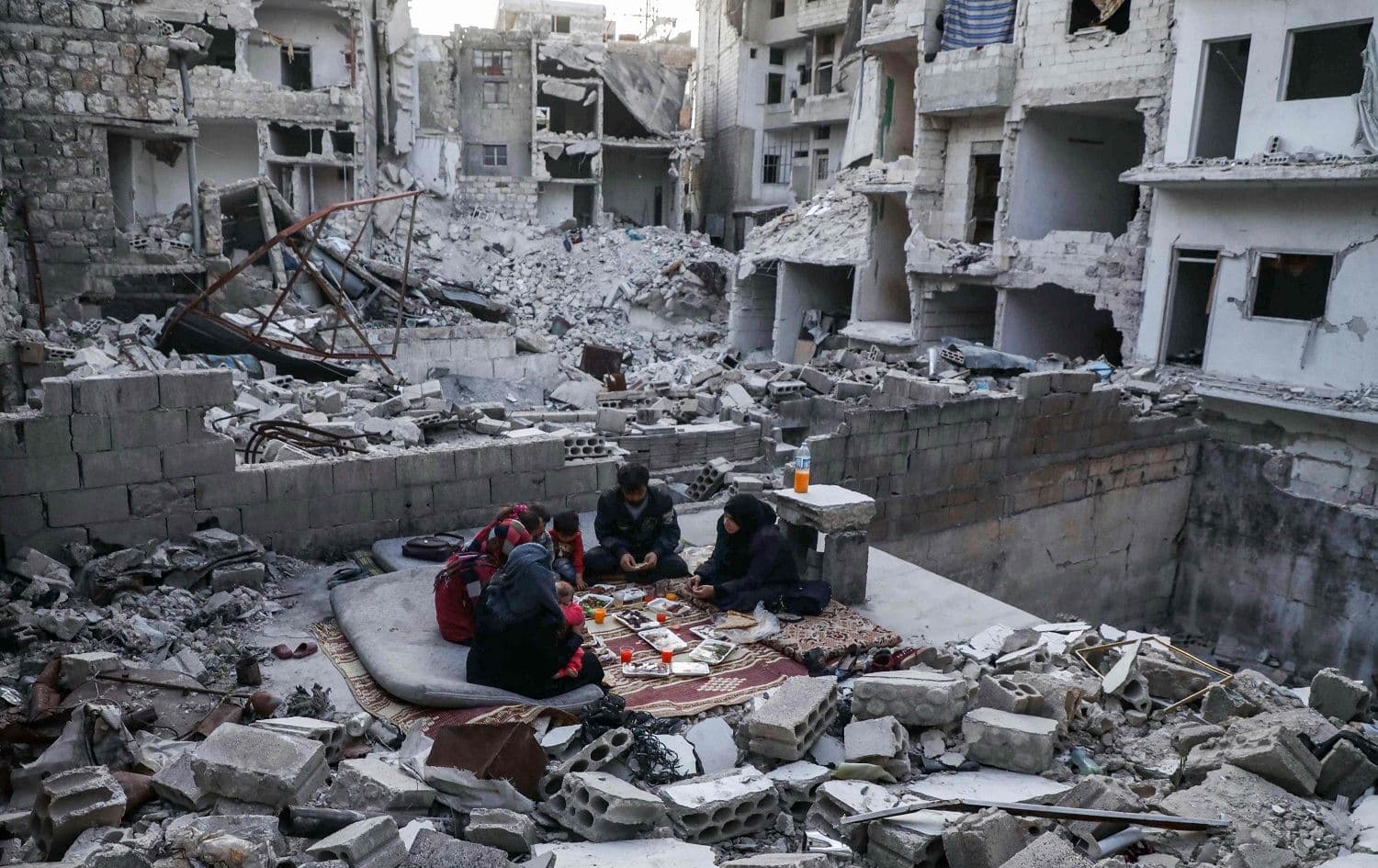 Tareq Abu Ziad and his family on the ruins of their home in Ariha, Syria, on May 4, 2020. Photo: Aaref Watad/AFP
