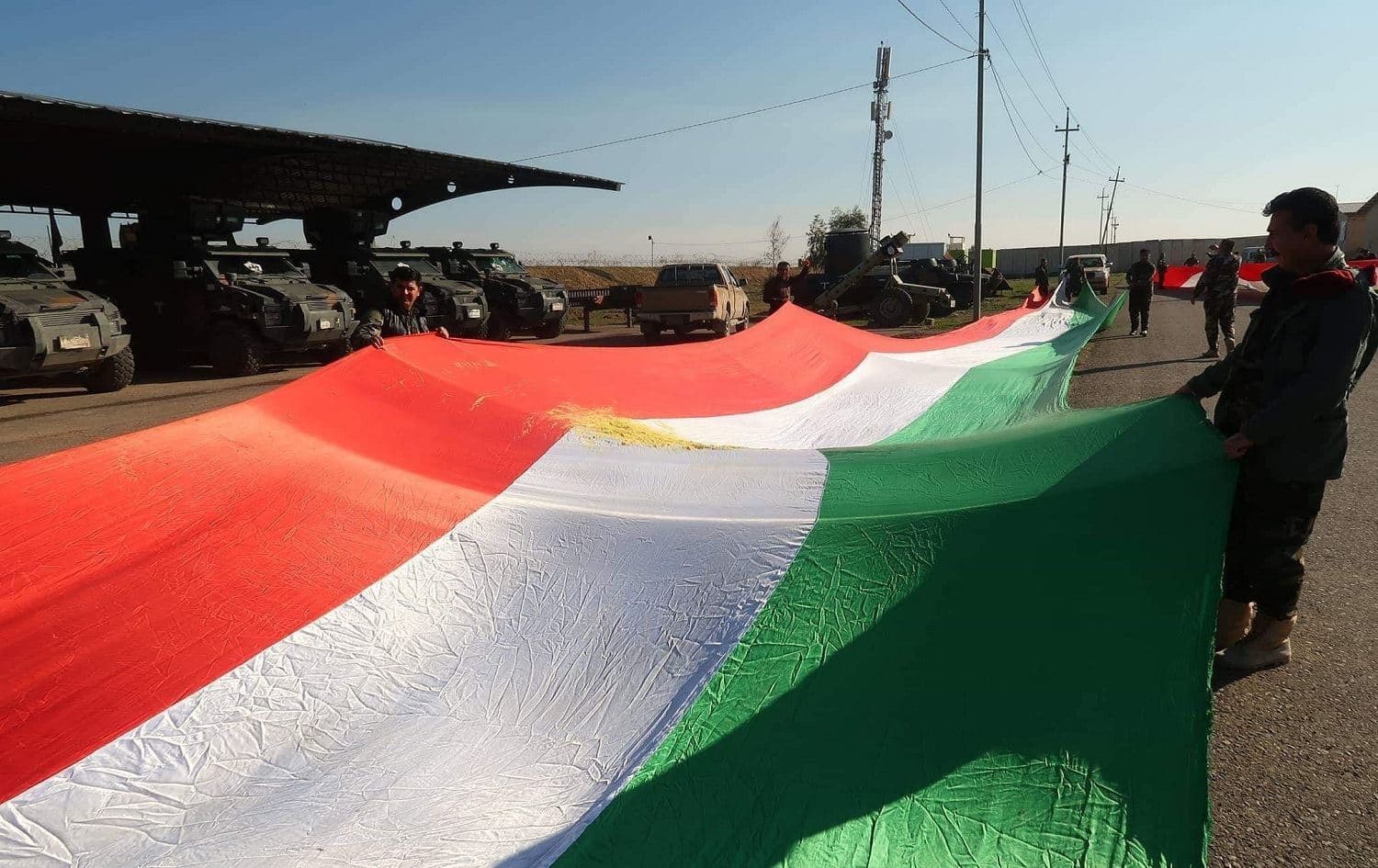 Peshmerga forces display a Kurdish flag. File photo: Rudaw