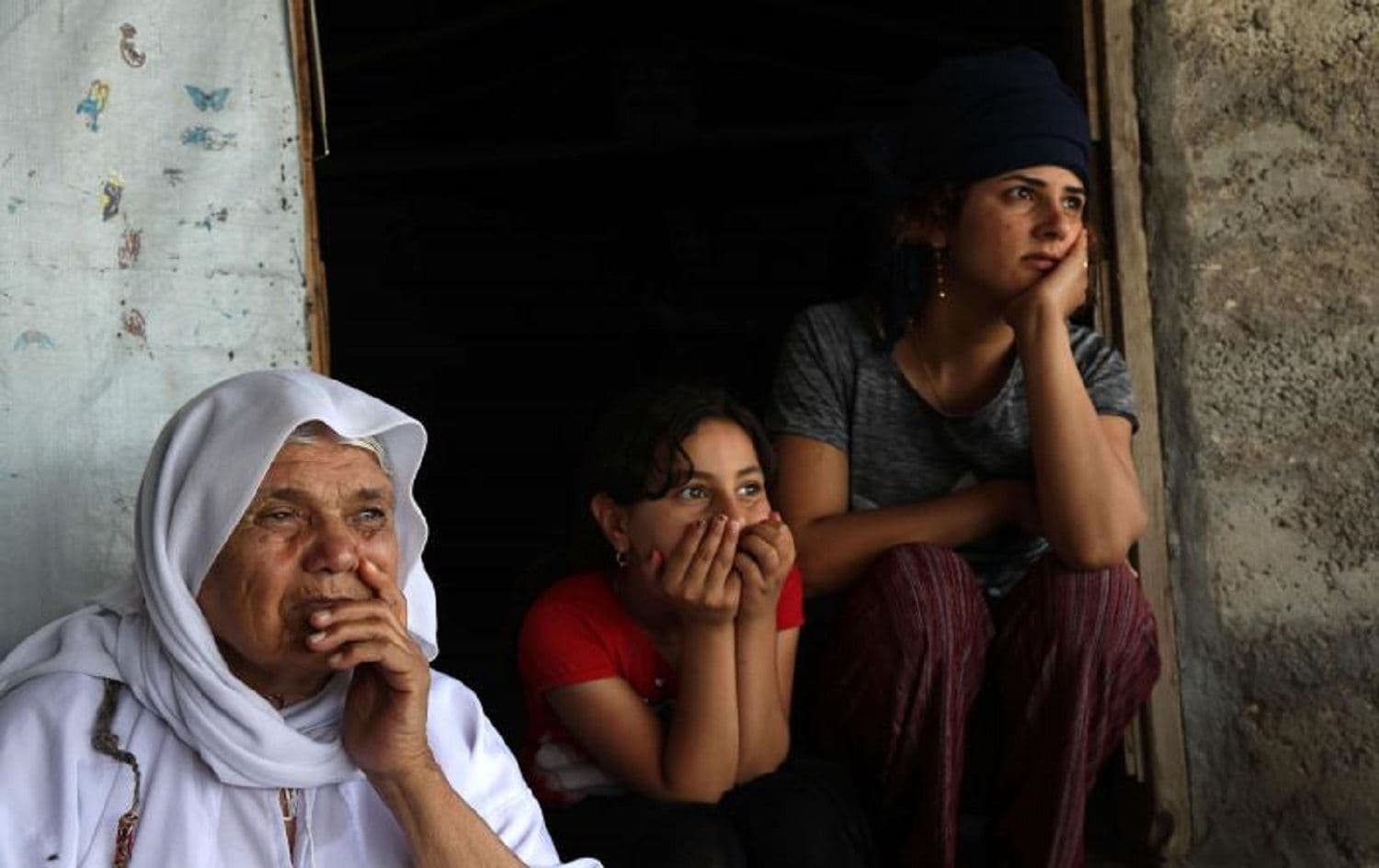 Displaced Yezidis sit outside a tent in Khanke camp, Duhok province. File photo: AFP