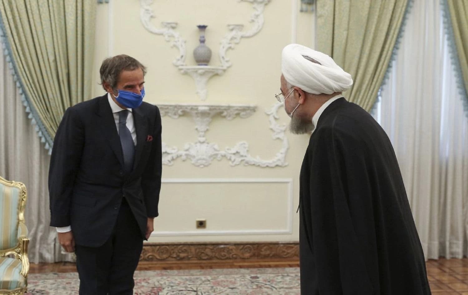 In this photo released by the official website of the office of the Iranian Presidency, President Hassan Rouhani, right, welcomes Director General of International Atomic Energy Agency, IAEA, Rafael Mariano Grossi for their meeting in Tehran, Iran, Wednesday, Aug. 26, 2020. Photo: Iranian Presidency Office via AP