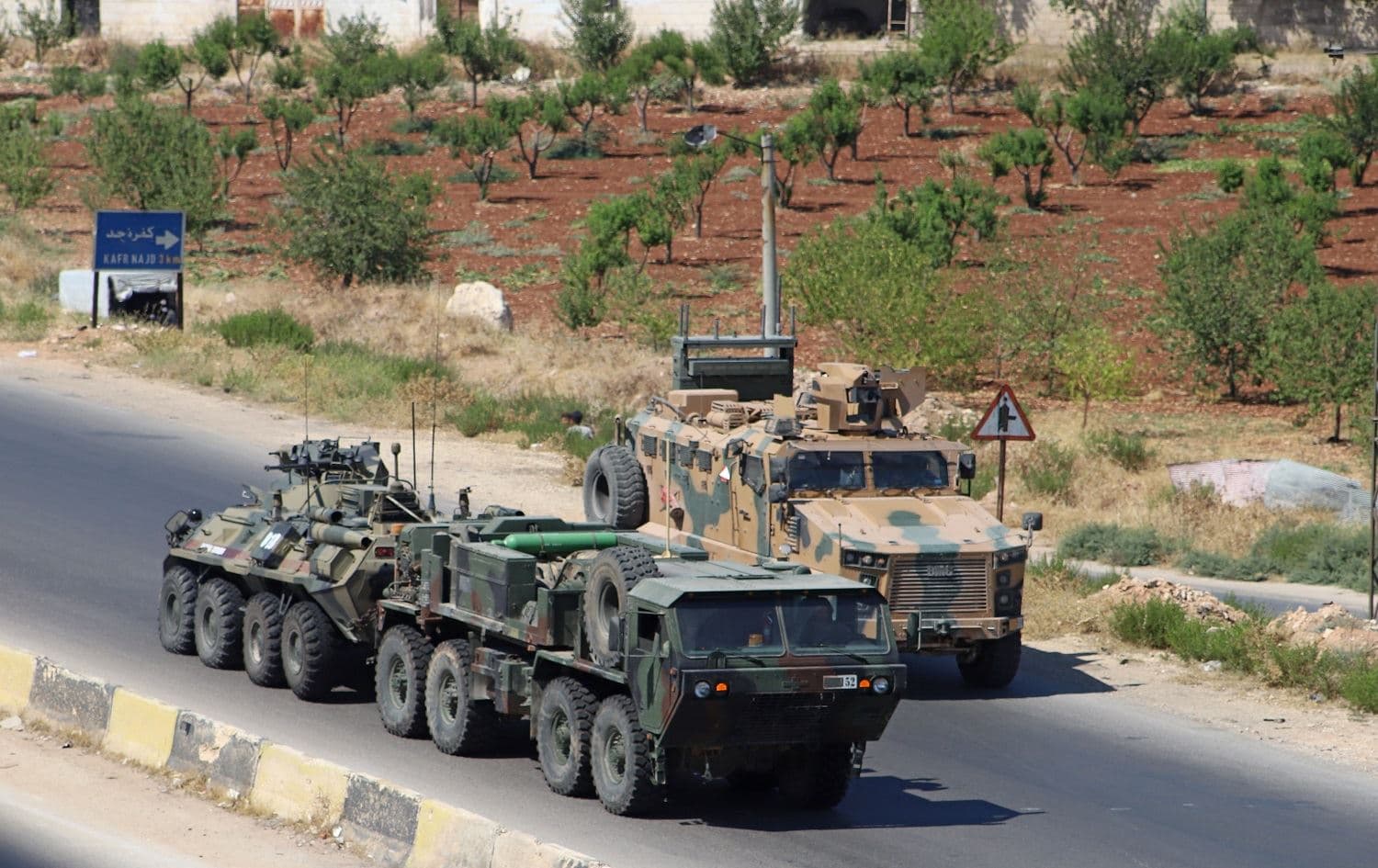 A Turkish-Russian military convoy tows a damaged vehicle after its joint patrol was reportedly targeted on the strategic M4 highway, near the Syrian town of Urum al-Jawz in the south of the northwestern Idlib province, on August 25, 2020. Abdulaziz Ketaz / AFP