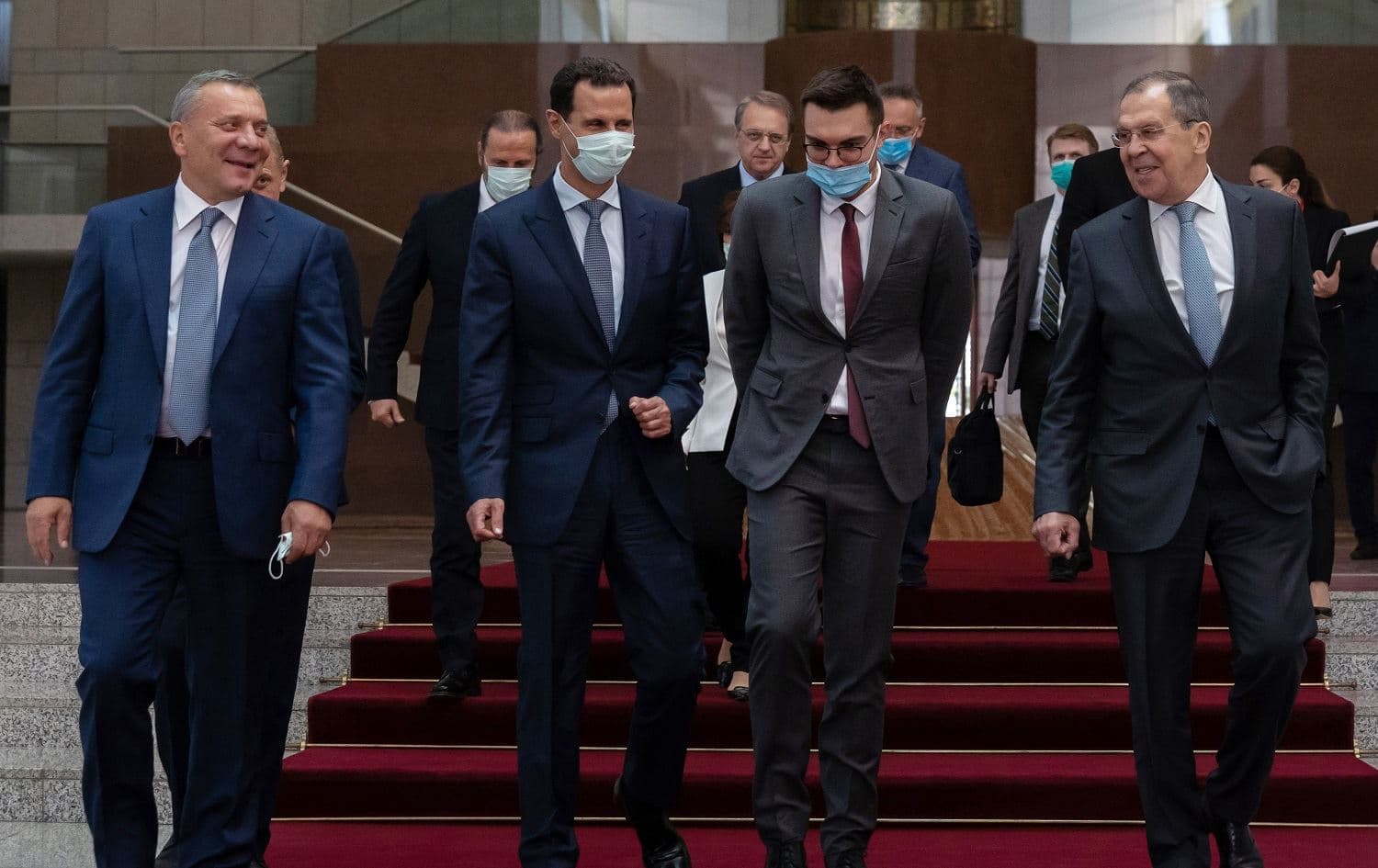 A handout picture released by the official Syrian Arab News Agency (SANA), shows Syrian President Bashar al-Assad (second from left) with Russian deputy prime minister Yuri Borisov (left) and foreign minister Sergey Lavrov (right) in Damascus on September 7, 2020. Photo: SANA / AFP