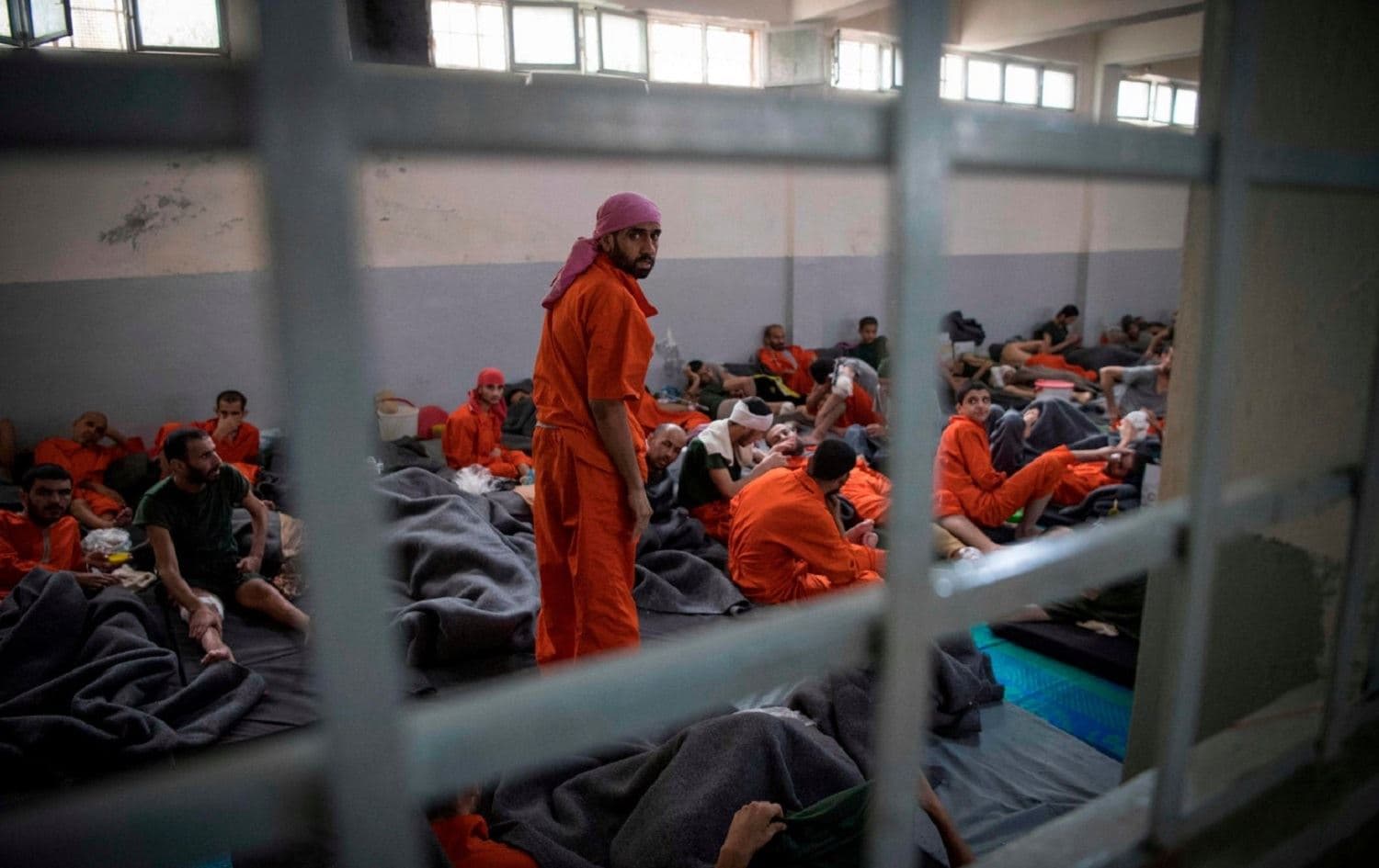 Men allegedly affiliated with ISIS sit in a prison in northeastern Syria. File photo: AFP