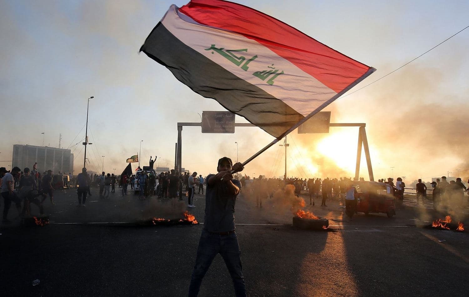 An Iraqi protester waves the national flag during a demonstration in the Iraqi capital Baghdad on October 5, 2019. Photo: Ahmad al-Rubaye / AFP
