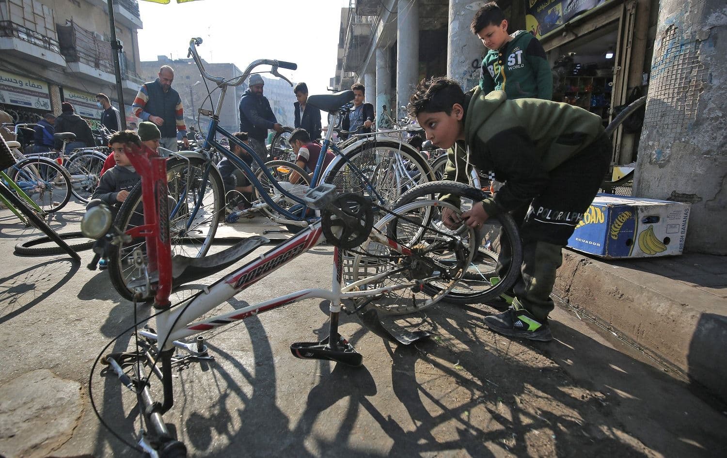 An Iraqi boy repairs bicycles in the Sadriya market in central Baghdad on January 15, 2021. Photo: Ahmad al-Rubaye/AFP