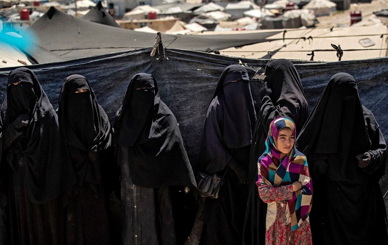 A girl stands in a line of women to receive aid at the Kurdish-run al-Hol camp in al-Hasaka, northeastern Syria. Photo: Delil Souleiman/AFP
