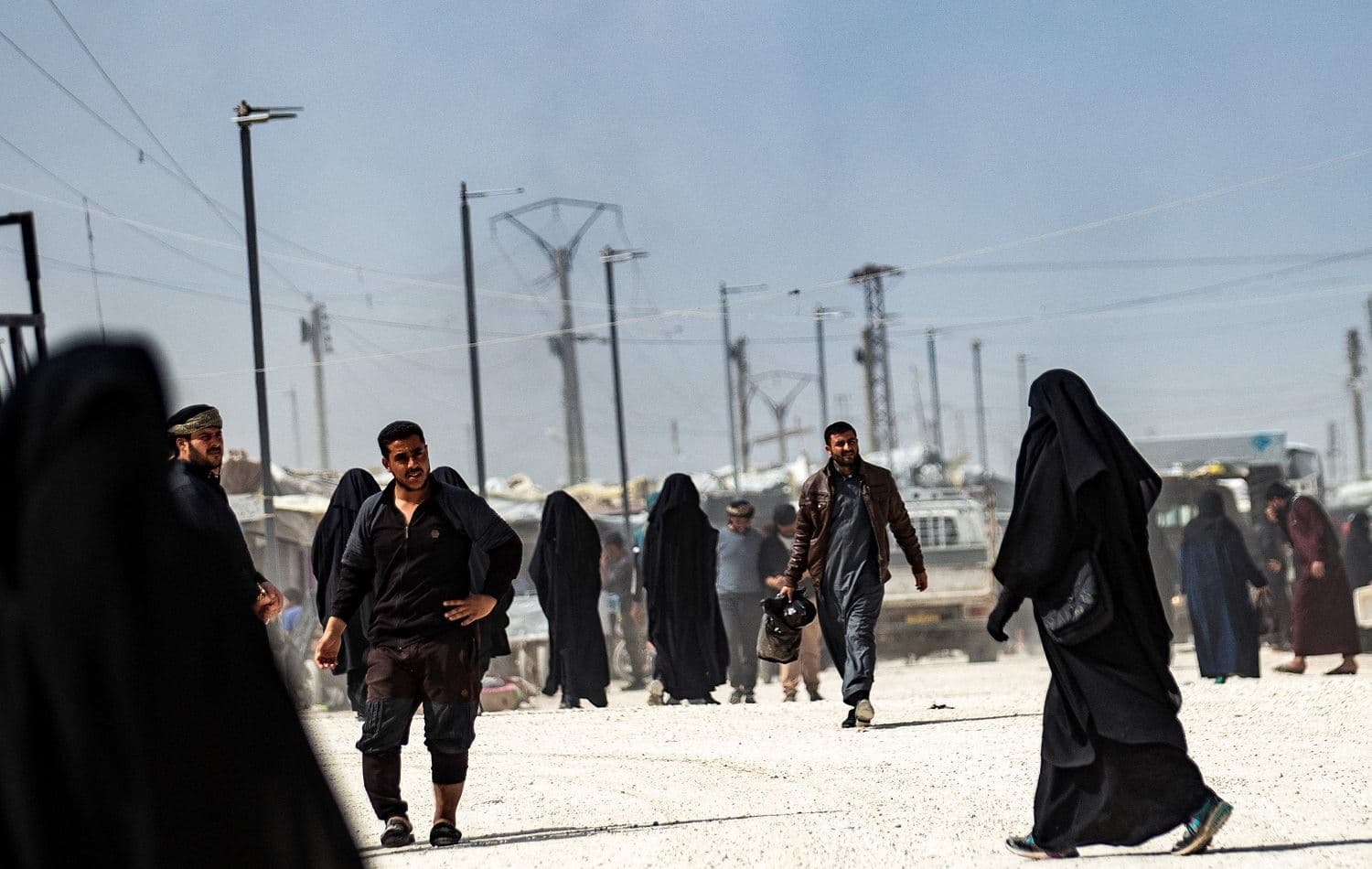 People walk at the Kurdish-run al-Hol camp, northeastern Syria on March 3, 2021. Photo: Delil Souleiman / AFP