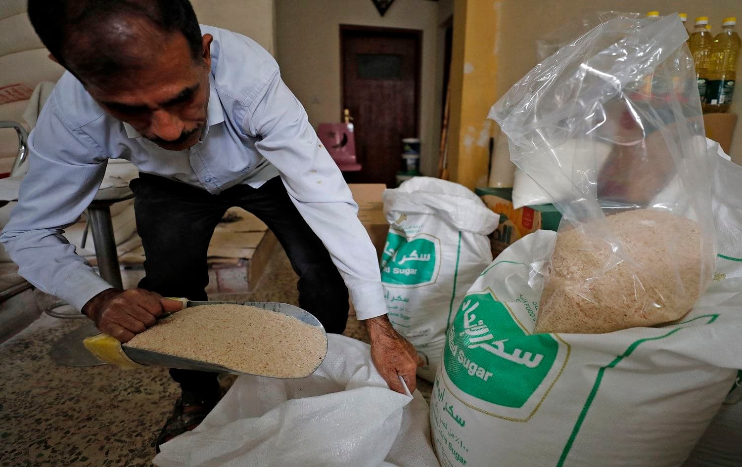 An Iraqi worker prepares food rations to be distributed to people in need at his warehouse in Baghdad's Karrada district on April 7, 2021. Photo: Ahmad al-Rubaye/AFP