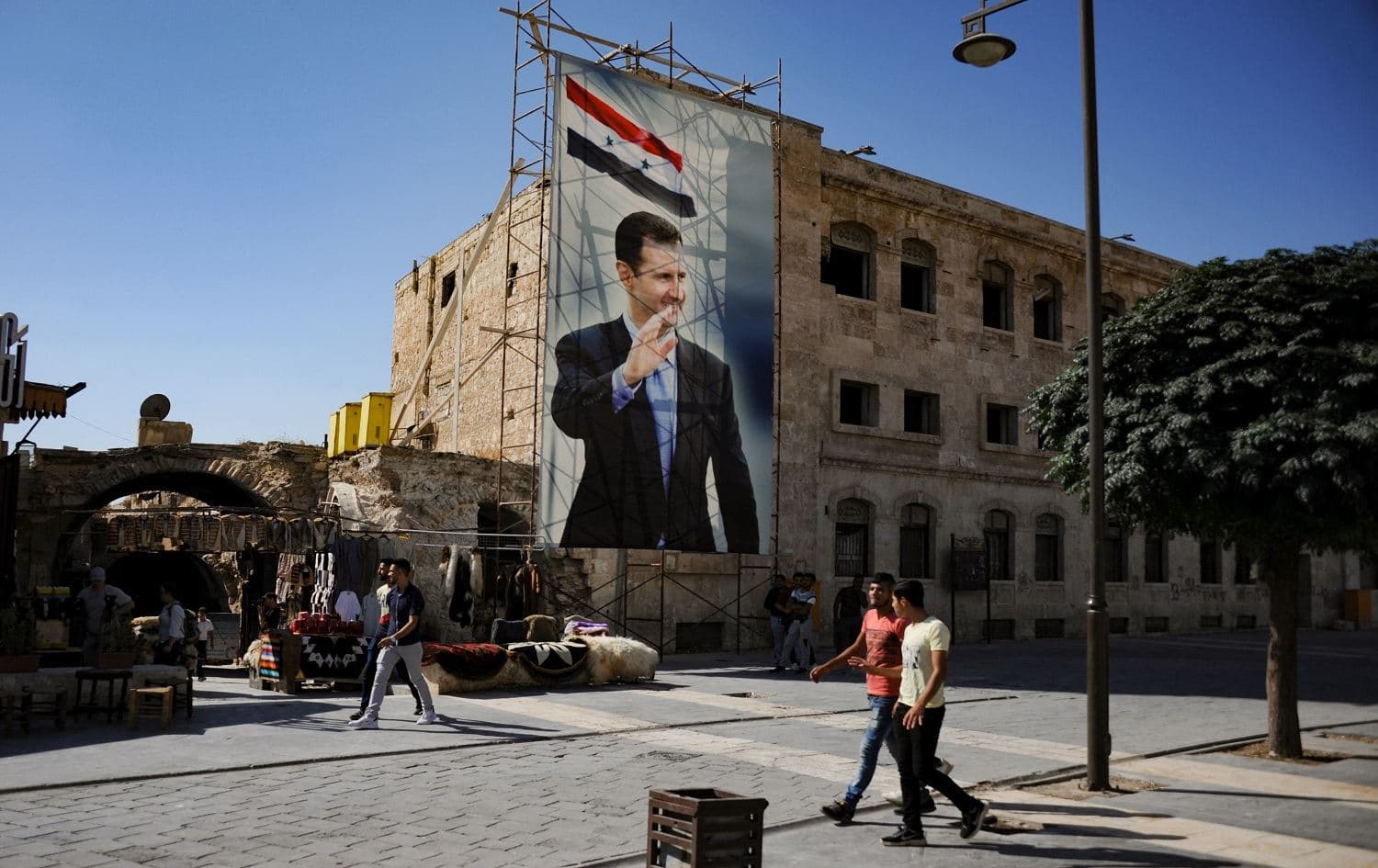 A poster of Bashar al-Assad in Aleppo's old city as seen during a guided tour by the Russian army. File photo: Maxime Popov/AFP