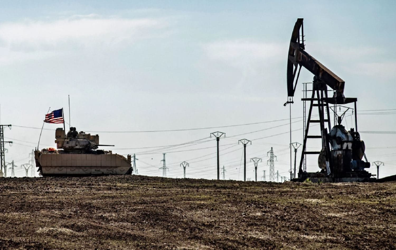 A US Bradley Fighting Vehicle patrols near oil production facilities in the Hasakah countryside February 2, 2021. Photo: Delil Souleiman/AFP