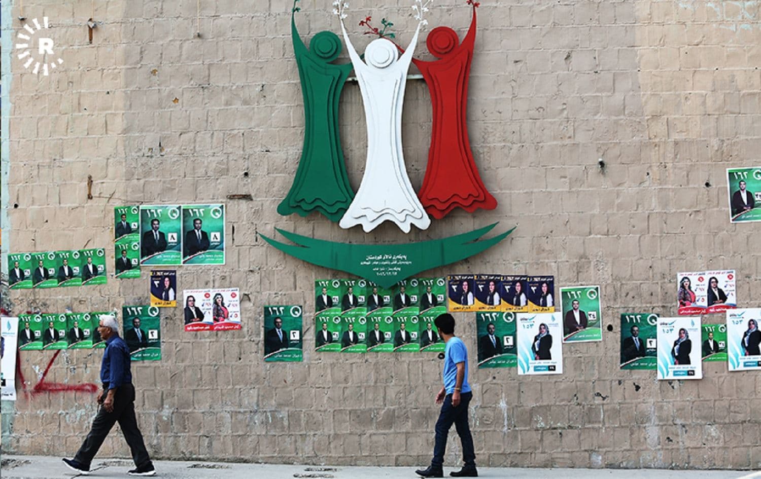 People walk past campaign posters in Sulaimani ahead of the 2018 Iraqi parliamentary election. File photo: Sartip Othman/Rudaw
