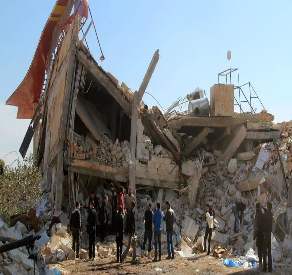 People gather around the rubble of a hospital supported by Doctors Without Borders (MSF) near Maaret al-Numan, in Syria's northern province of Idlib, on February 15, 2016. Photo: Ghaith Omran/AFP
