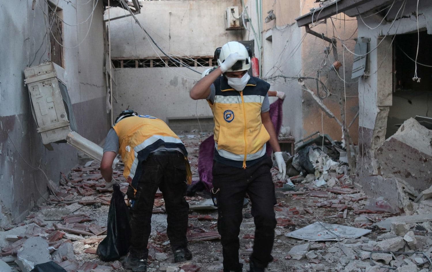 Members of Syria's Civil Defence service (White Helmets) sift through the rubble at al-Shifaa hospital following shelling of the rebel-held city of Afrin in northern Syria, on June 12, 2021. Photo: Bakr Alkasem/AFP