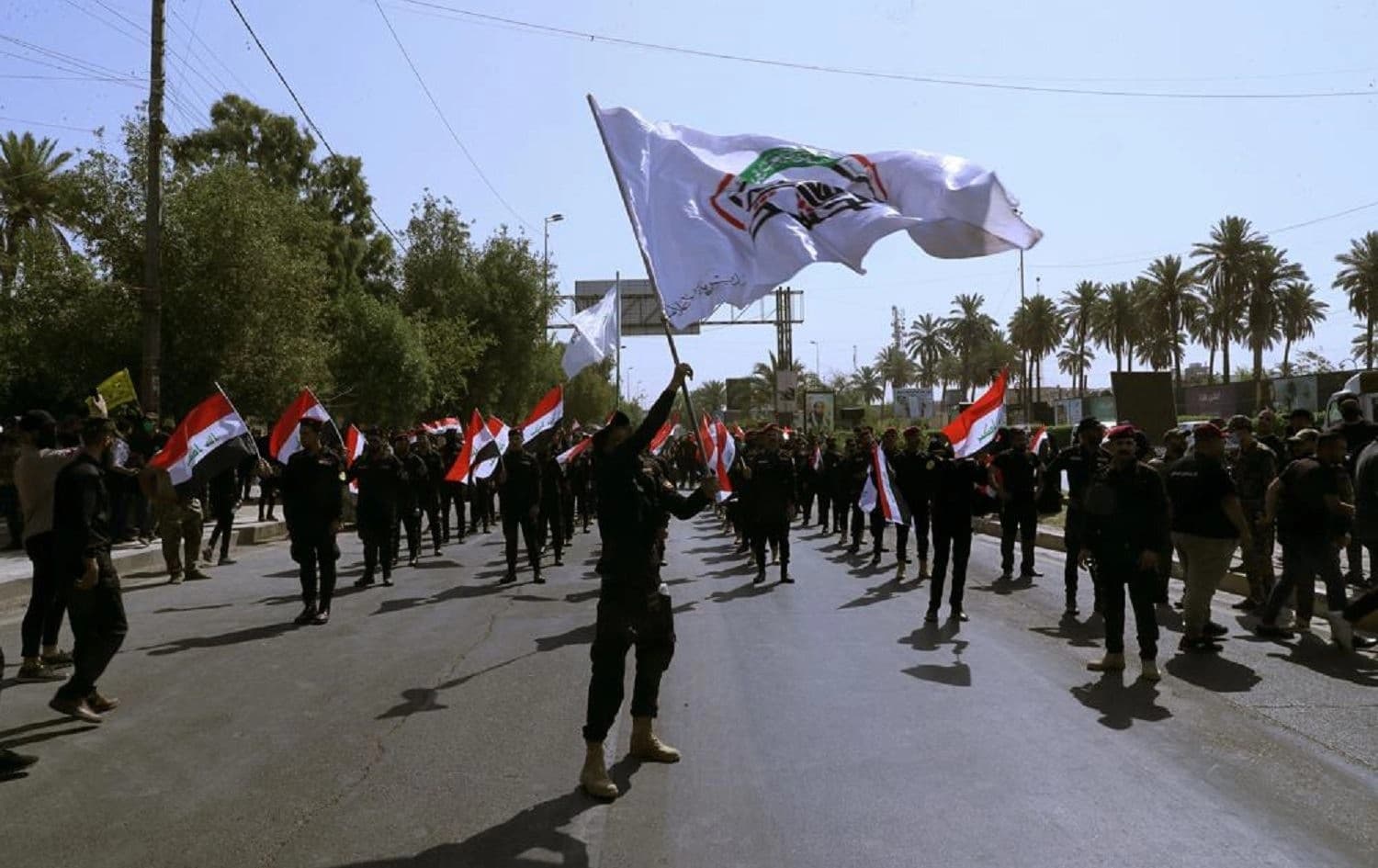 Iran-backed militia fighters march in central Baghdad on June 29, 2021. Photo: Khalid Mohammed/AP