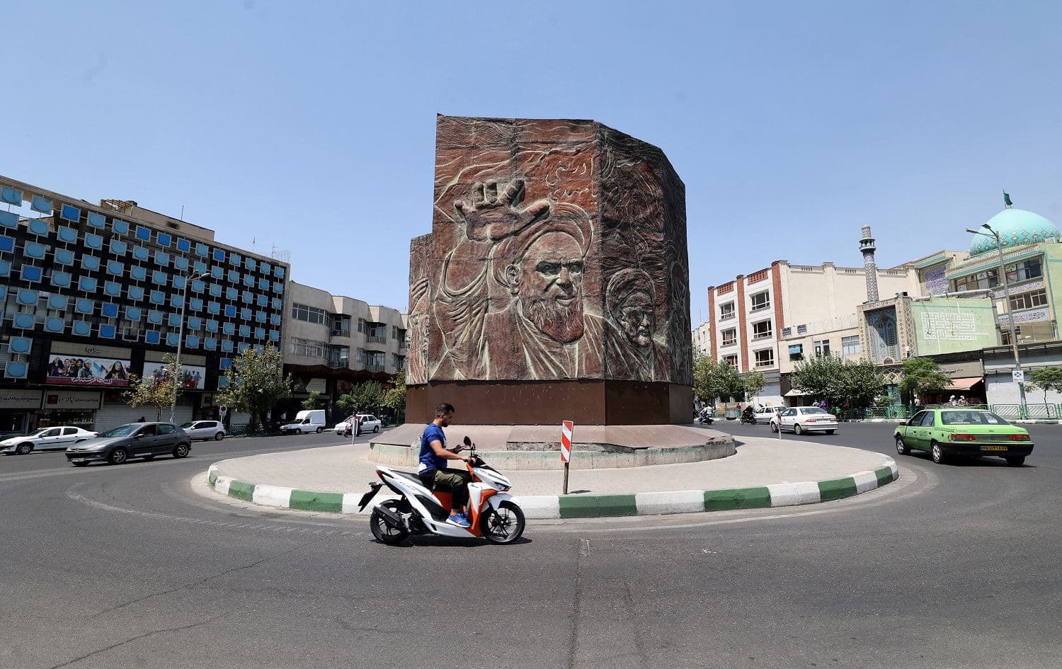 An Iranian man rides a motorbike at Enghelab square in the centre of Tehran, on July 20, 2021. Photo: Atta Kenare/AFP