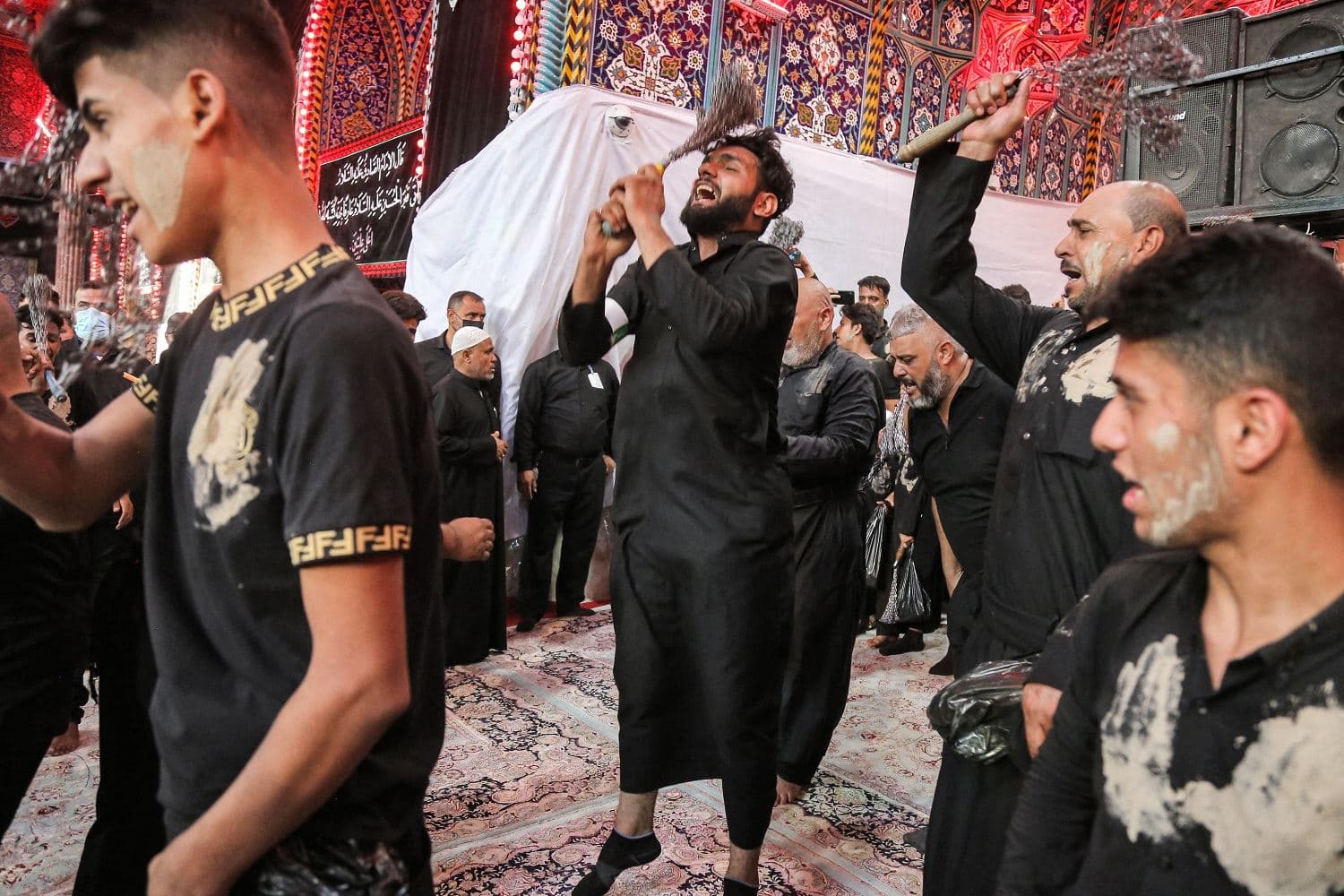 Shiite Muslim worshippers self-flagellate as part of a mourning ritual during the month of Muharram leading up to the day of Ashura at the Imam Hussein shrine in Iraq's holy city of Karbala, on August 18, 2021.Photo: Mohammed Sawaf / AFP