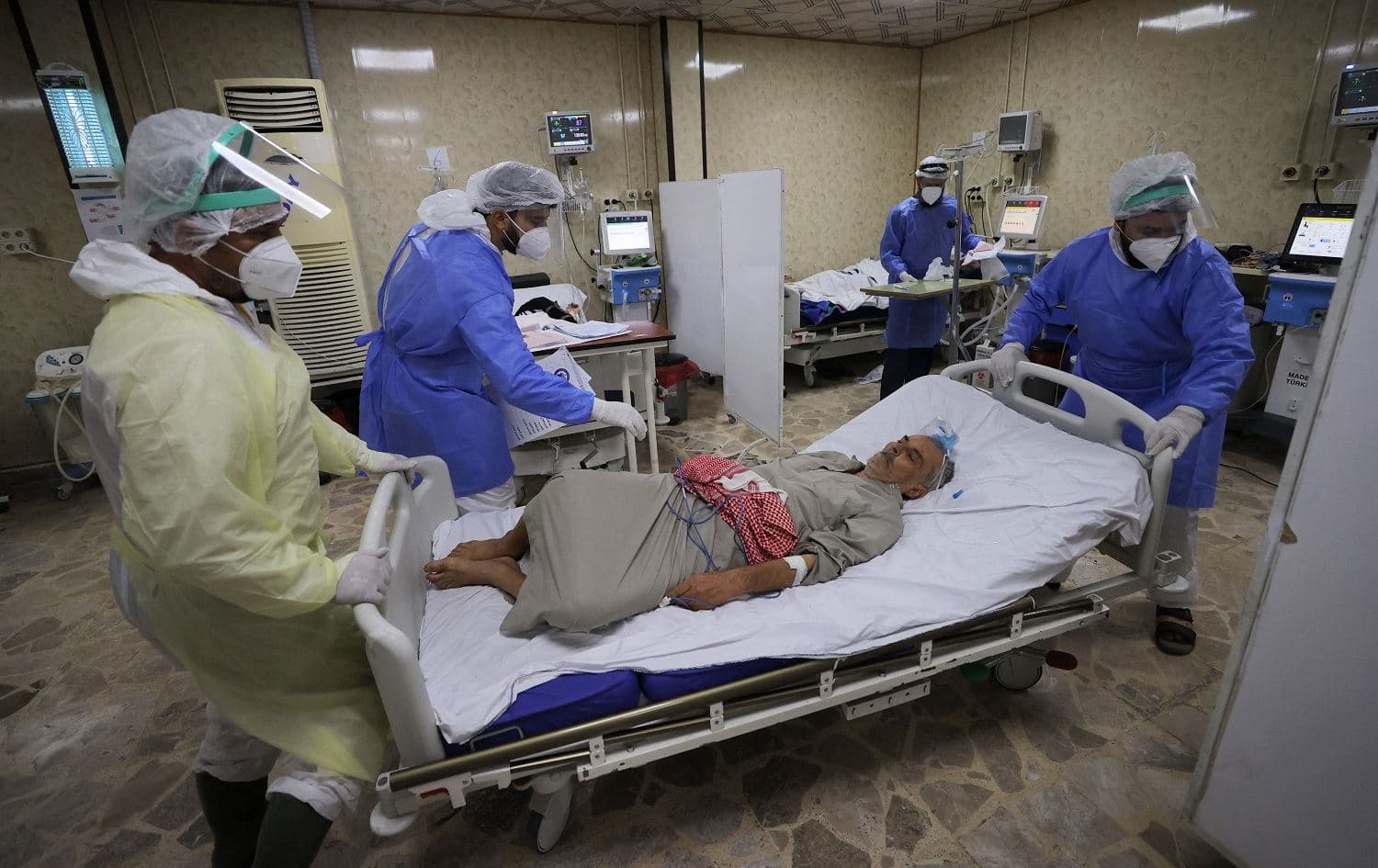 Syrian health workers tend to a Covid-19 patient at a hospital in the rebel-held northwestern city of Idlib on September 13, 2021. Photo: Omar Haj Kadour/AFP
