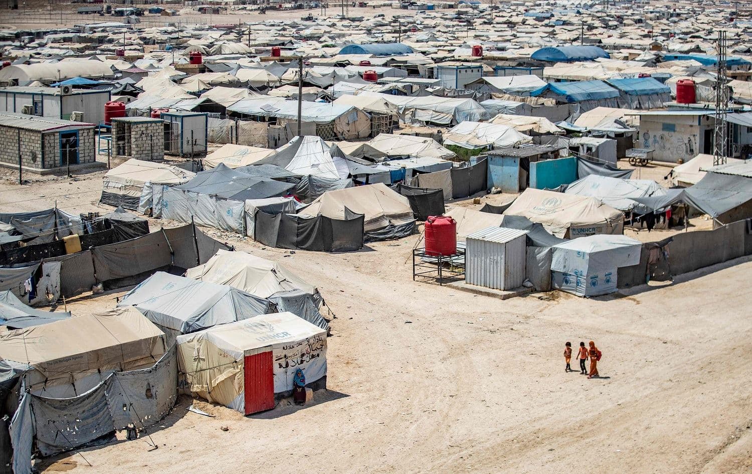 Children walk among shelters in northeast Syria's al-Hol camp on August 2, 2021. Photo: Delil Souleiman/AFP