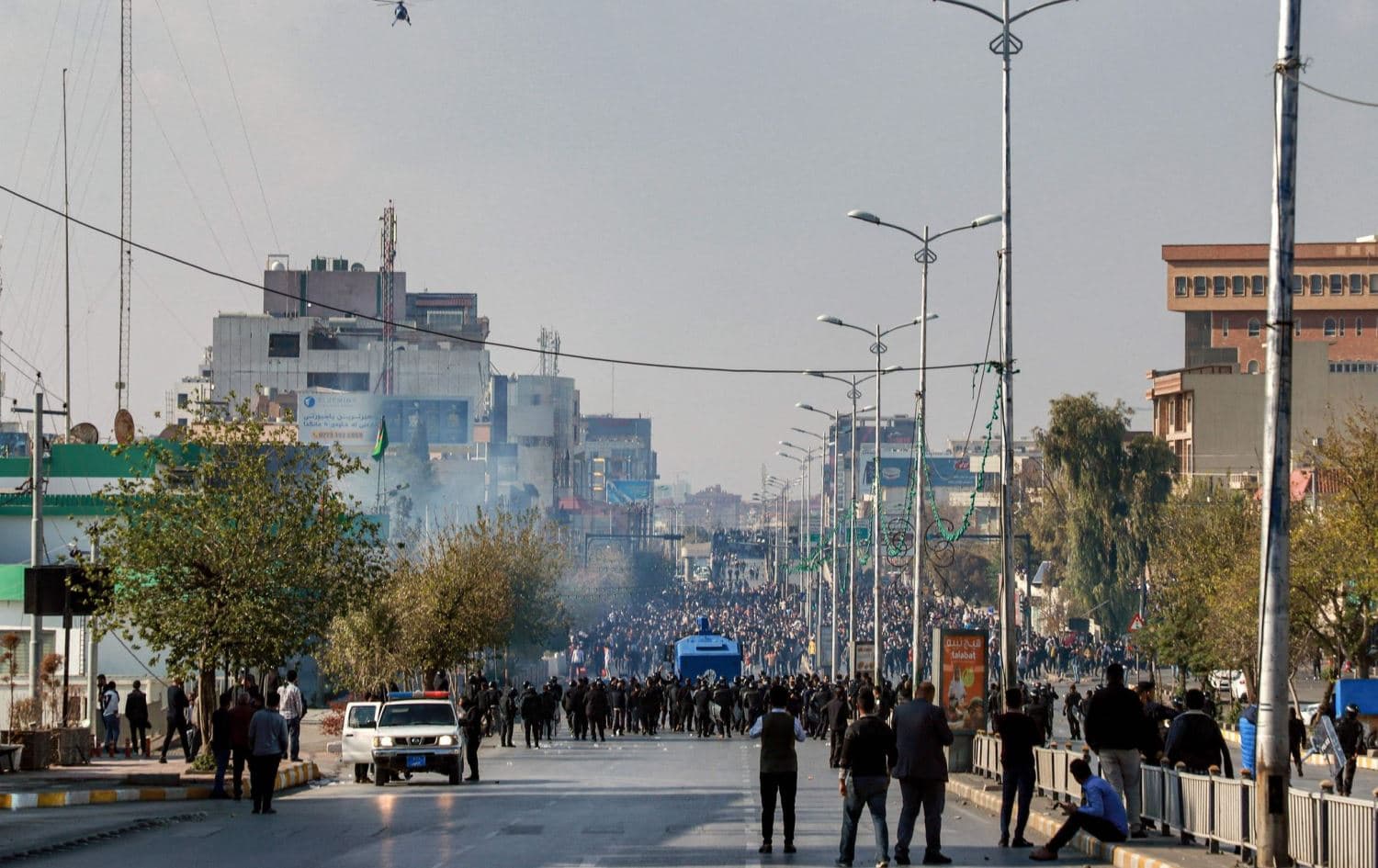 Kurdish security forces try to disperse a protest by university students demanding the payment by the government of monthly allowances on November 23, 2021 in Sulaimani. Photo: Shwan Mohammed/AFP
