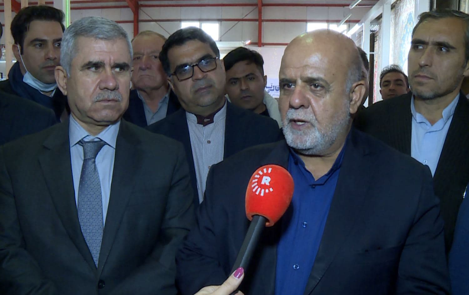 Iranian Ambassador to Iraq Iraj Masjedi (second from right) speaks to Rudaw reporter at the Erbil fair on December 21, 2021. Photo: screengrab/Rudaw
