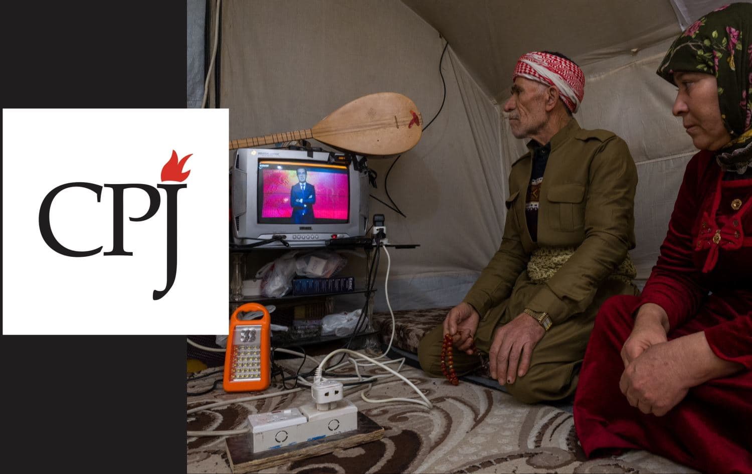 From left: CPJ logo, and a Rojava family watching Rudaw's bulletin on Rojava in Bardarash camp on February 8, 2022. Photo: Rudaw