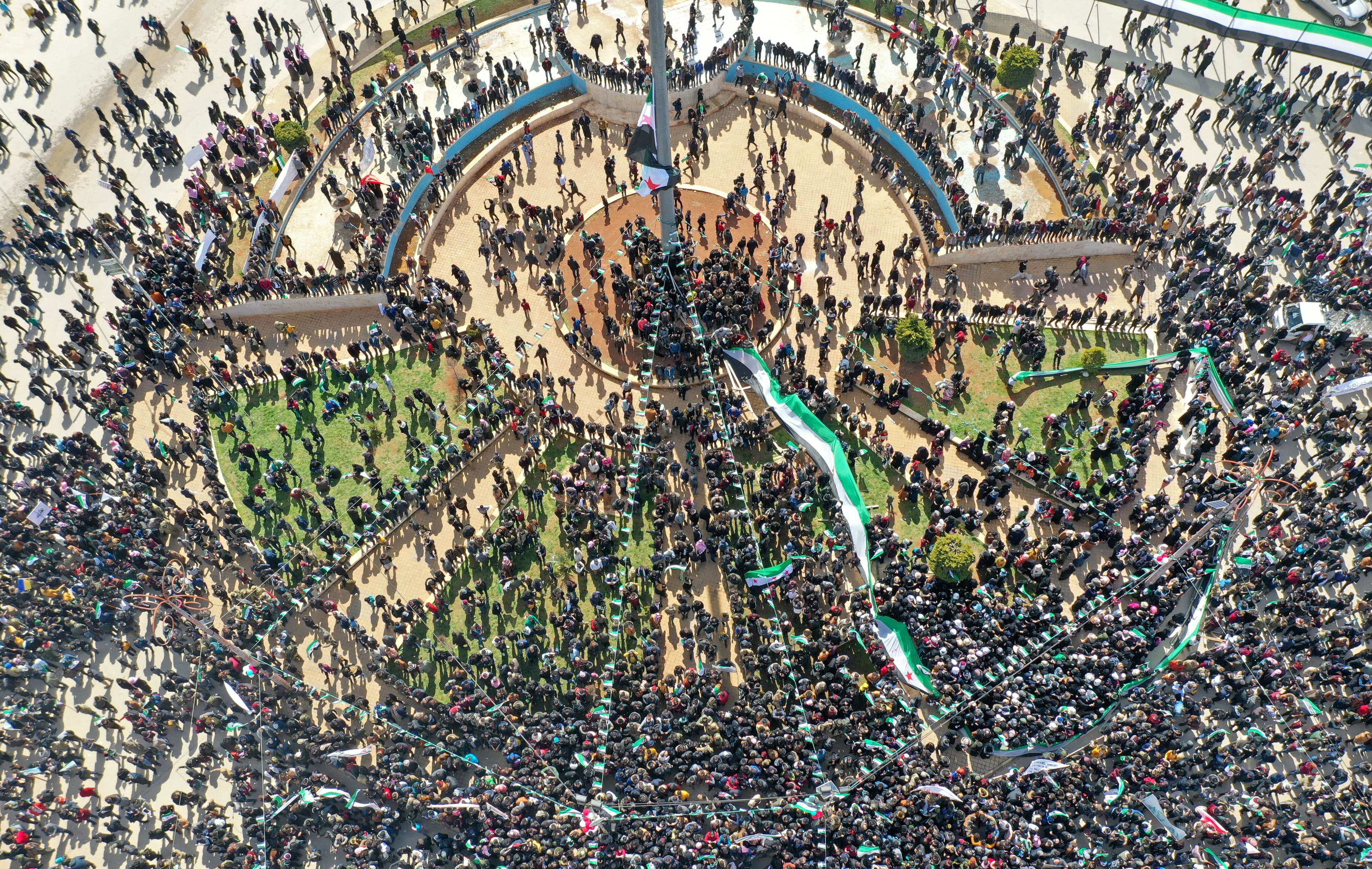 Syrians gather on the main square in the rebel enclave of Idlib on March 15, 2022, marking 11 years since the uprising. Photo: Omar Haj Kadour/AFP