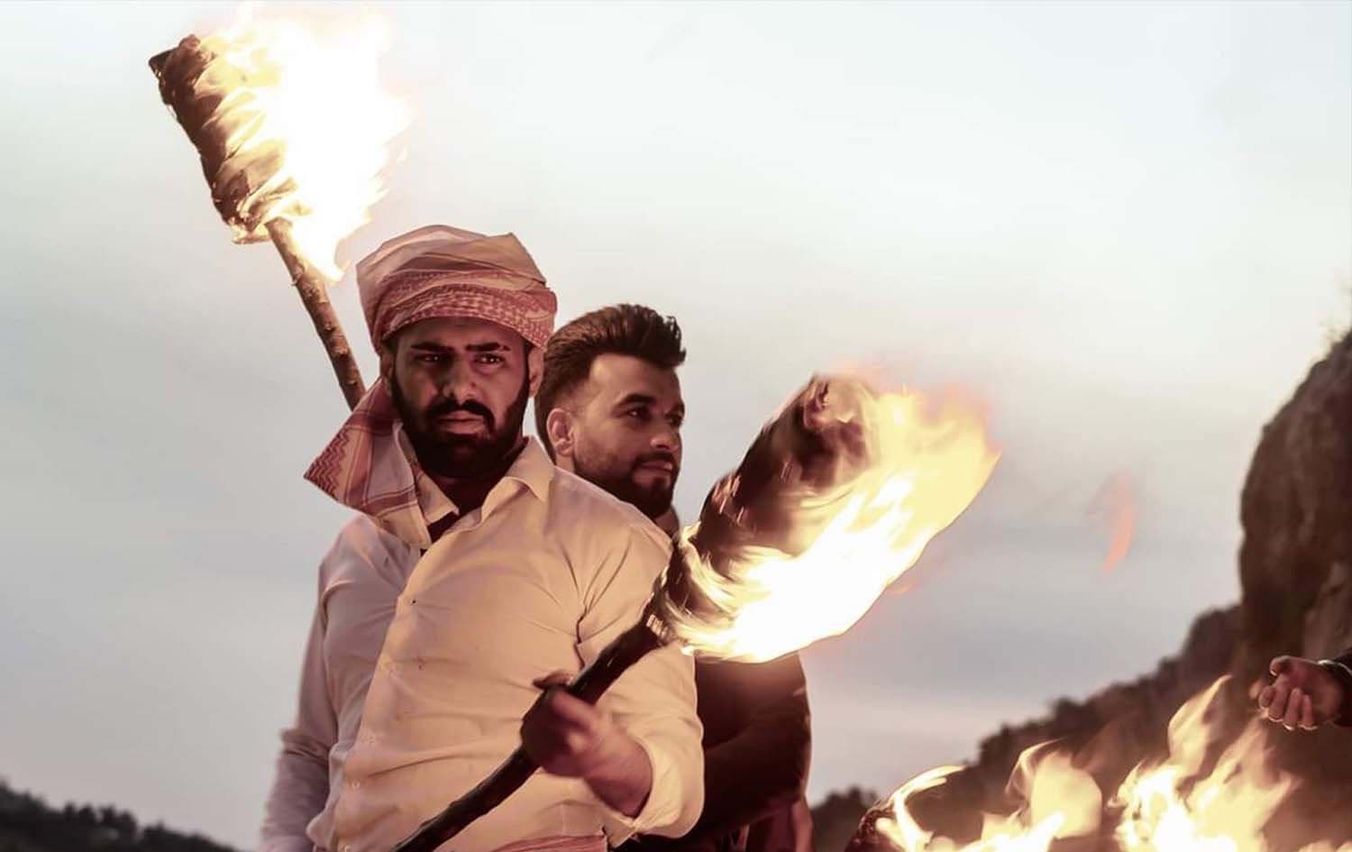 People carry torches on the Akre Hill as part of the Newroz celebrations in Duhok on March 20, 2019. Photo: Bilind T. Abdulla /Rudaw