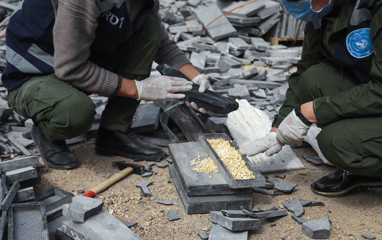 Kurdish security forces uncovering captagon pills during a warehouse bust in Qamishli, northeast Syria. Photo: Delil Souleiman/AFP