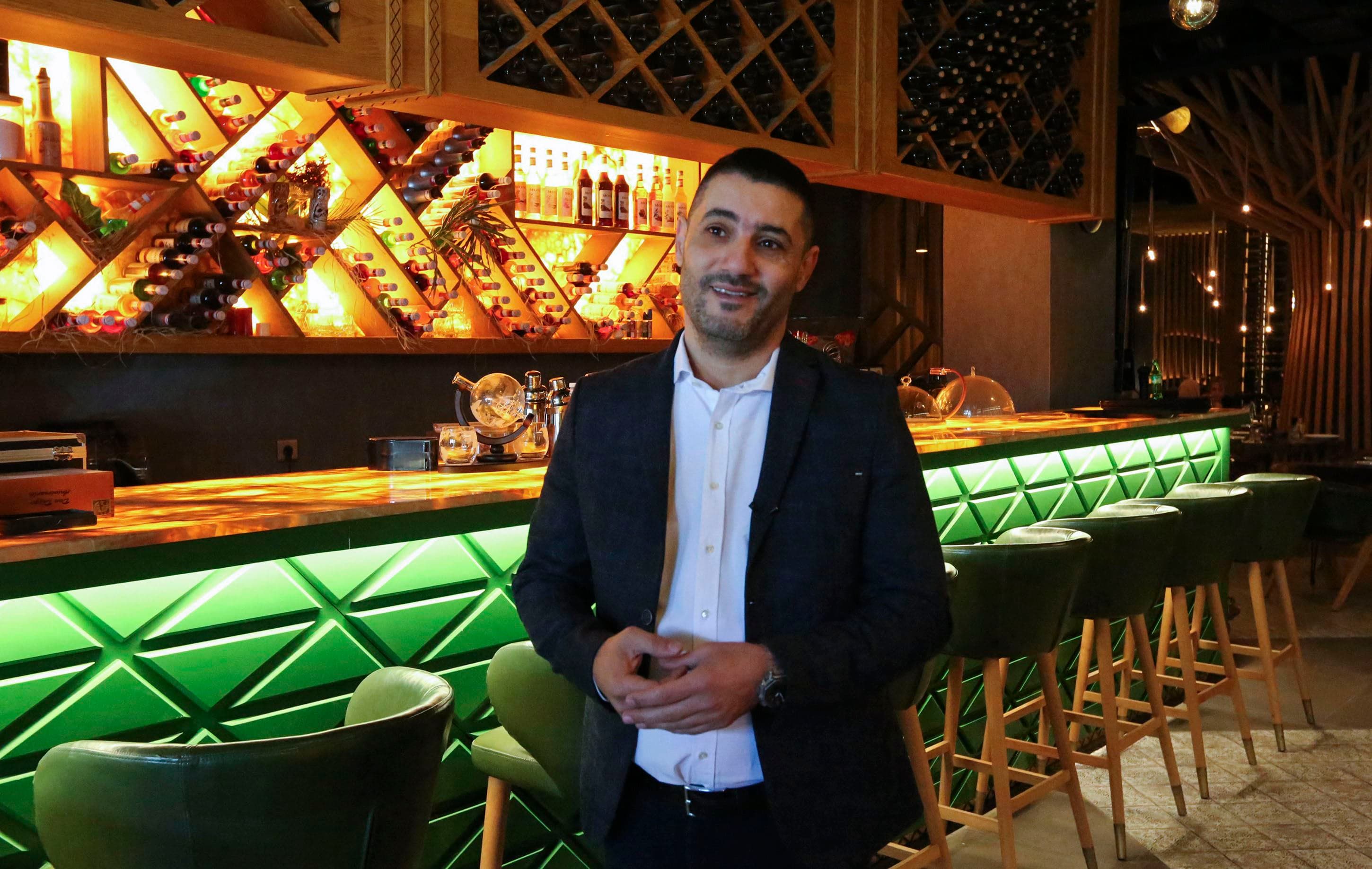 Lebanese restaurateur Akram Johari speaks during an interview at his restaurant in the Iraqi capital Baghdad, on March 16, 2022. Photo: Sabah Arar/AFP