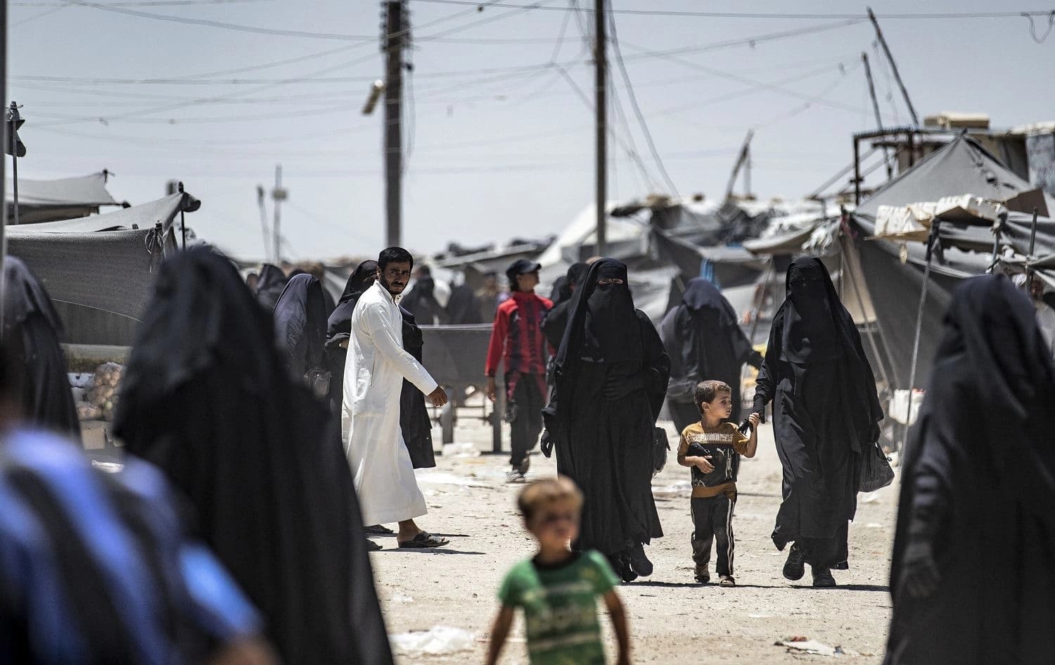 People walk in al-Hol camp in Hasakah, northeast Syria. Photo: Delil Souleiman/AFP