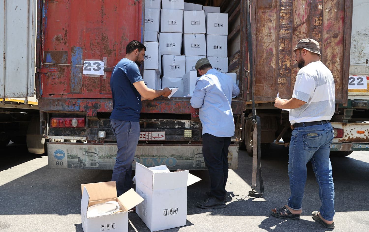 Customs officers inspect a convoy of humanitarian aid after crossing into Syria from Turkey through the Bab al-Hawa border crossing on July 8, 2022. Photo: Omar Haj Kadour/AFP